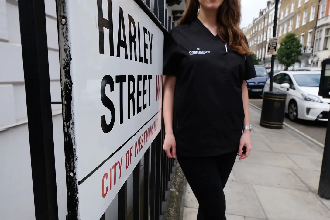 Cosmedocs staff member standing by iconic Harley Street sign in London's premier medical district
