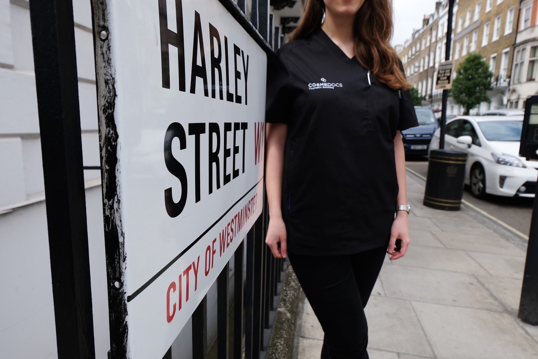 Cosmedocs staff member standing by iconic Harley Street sign in London's premier medical district