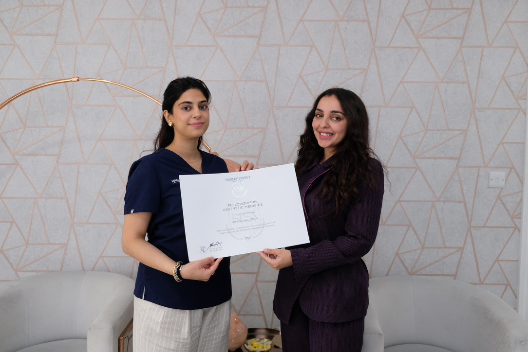 Aesthetic medicine fellowship certificate presentation ceremony with medical professionals